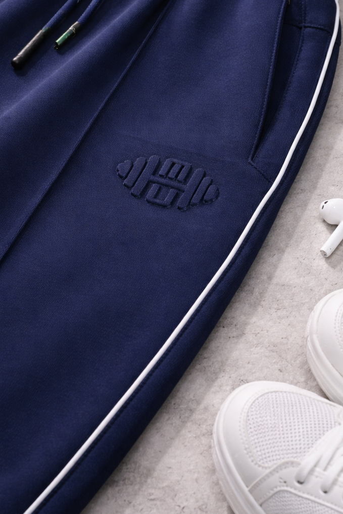 Close-up van een luxe sportbroek voor dames met subtiel logo in reliëf (embossed) voor een minimalistische uitstraling.